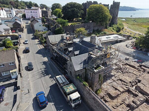 Island House in its town: Wogan Street sweeping up past the house, with Laugharne Castle and the estuary beyond.